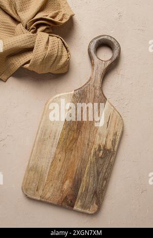 Cutting board, wooden, rectangular shape, with handle, with kitchen towel, top view, no people Stock Photo