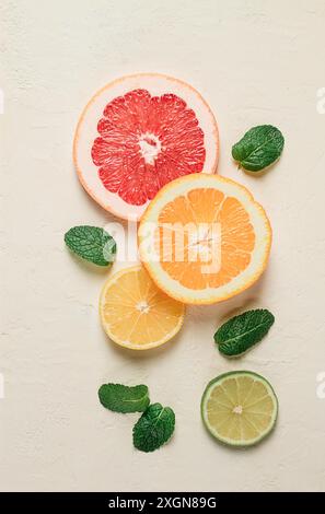 Food concept, wallpaper, sliced citrus fruits, top view, on a light table, with mint leaves, food background Stock Photo