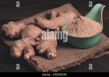 Ground and fresh ginger root, on a wooden table, rustic style, selective focus, no people Stock Photo