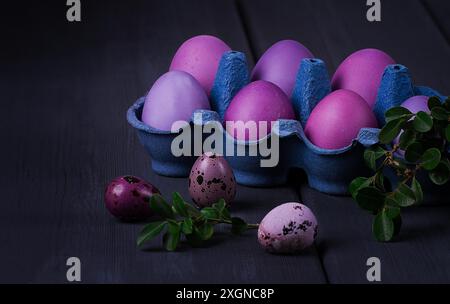 Easter eggs, purple and lilac, on a gray wooden table, Easter card, banner, selective focus, horizontal Stock Photo