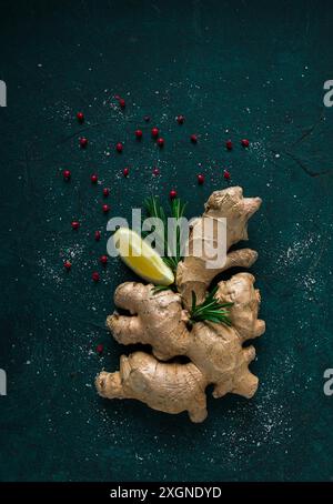 Ginger root, on a dark background, with rosemary, lemon and pepper, concept, food background, no people Stock Photo