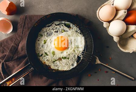 Breakfast, fried egg, in a cast-iron frying pan, top view, horizontal, no people Stock Photo