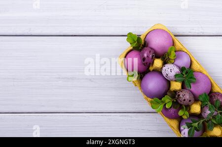 Easter eggs, purple and lilac, on a white wooden table, Easter card, banner, selective focus, horizontal Stock Photo