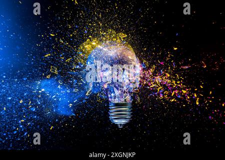 Light bulb exploding colorful powder,  innovation creative concept Stock Photo
