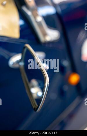 Car Rear View Mirror on the Side of a an Old Classic Car in Switzerland Stock Photo