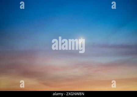 Crescent moon on dark sky Stock Photo