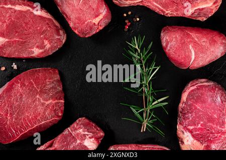 Meat, many different cuts, forming a frame on a dark slate background, with copy space Stock Photo