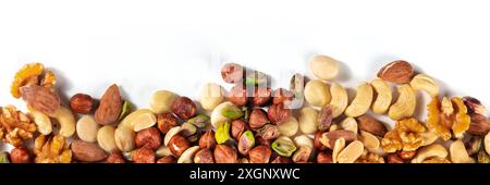 Nuts panorama with a place for text. A mix of peanuts, hazelnuts, walnuts, pistachios, cashews and almonds, shot from the top Stock Photo