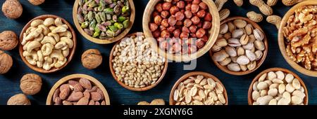Nuts panorama. Many different nuts, shot from above on a dark background Stock Photo