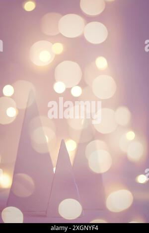 Blurred holiday background with christmas trees and bokeh garland lights Stock Photo