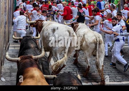 Pamplona, Spain. 10th July, 2024. Several runners run in front of the bulls from the Fuente Ymbro ranch through the streets of Pamplona during the San Fermín 2024 festivities. (Photo by Fernando Pidal/SOPA Images/Sipa USA) Credit: Sipa USA/Alamy Live News Stock Photo