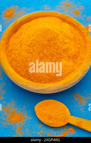 ground turmeric on blue background Stock Photo - Alamy