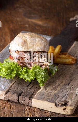 Pulled pork in a bun with fries Stock Photo
