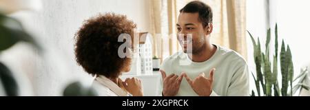 A couple communicates using sign language in their home. Stock Photo