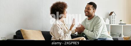 A loving couple using sign language to communicate at home. Stock Photo