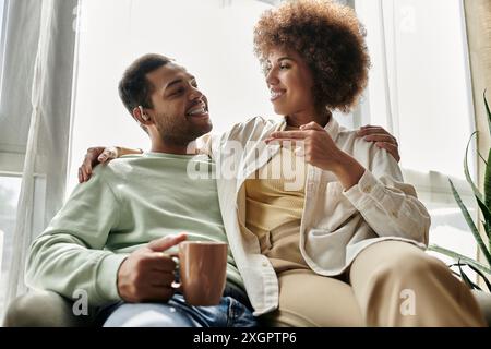 An African American couple shares a loving conversation using sign language at home. Stock Photo