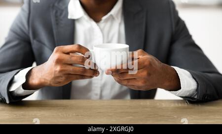 African american businessman drinking coffee at workplace Stock Photo