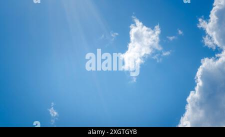 White clouds on the blue sky perfect for the background. Clear blue sky and white clouds. Blue sky background with clouds. Stock Photo