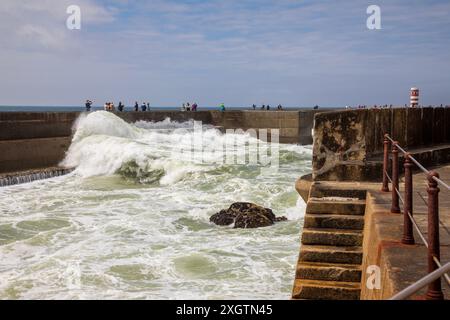 Porto, Portugal - 16th June 2024;  Breakwater with Farolins da Barra do Douro lighthouse in Porto city Stock Photo