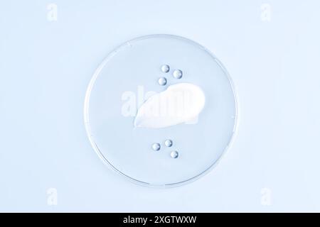 A high-resolution image featuring artistic smears of cosmetic cream on a blue background, perfect for beauty and skincare themes Stock Photo