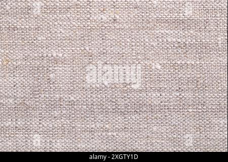 Surface of coarse linen fabric, from above. Very absorbent and strong textile made from the fibers of the flax plant. Stock Photo
