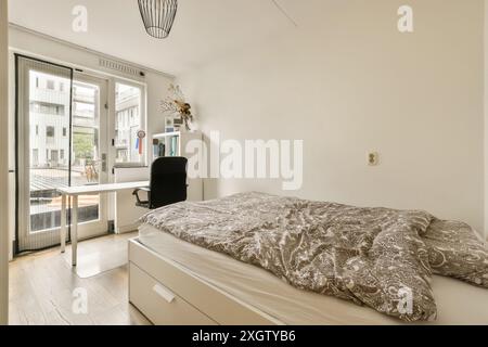 Bright and cozy modern bedroom featuring a sleek design, balcony access, and natural light in Henkenshage, Amsterdam Stock Photo