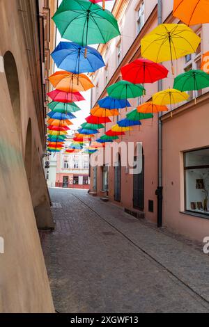 2023-05-28; colored umbrellas hanging on one of the streets, Tarnow, Poland. Stock Photo