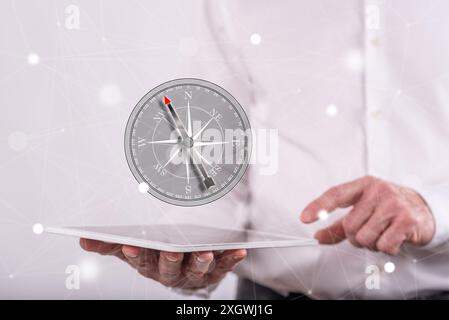 Right direction concept above a tablet held by a man in background Stock Photo