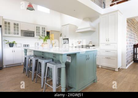 Central island with bar stools in bright kitchen of luxury home, copy space. Interior decoration, furniture, architecture, home and domestic life. Stock Photo