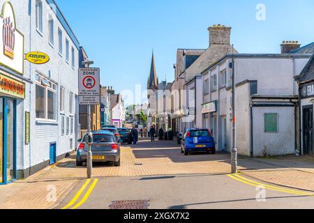 The entrance to the pedestrian only old town at Point Street, with Martin's Memorial Church tower behind, in the seaside village of Stornoway Scotland Stock Photo