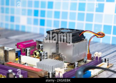 A PC motherboard on a wooden table. Stock Photo