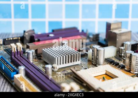 A PC motherboard on a wooden table. Stock Photo