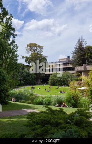 People enjoying the good weather in the park of the Calouste Gulbenkian Museum, located in the centre of Lisbon, the capital city of Portugal. Stock Photo