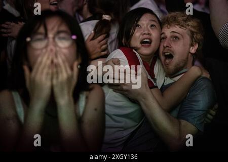 London, UK. 10th July 2024. EURO 2024: England vs Netherlands. 4TheFans Fan Park at Village Underground fanzone event in Shoreditch. England fans react and celebrate after beating the Netherlands 2 – 1 in Dortmund with a last gasp goal from substitute Ollie Watkins securing a victory for England in dramatic fashion minutes after Bukayo Saka had an effort ruled offside. Credit: Guy Corbishley/Alamy Live News Stock Photo