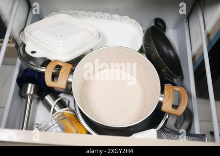 A kitchen drawer full of various utensils and cookware for storage and organization in the household Stock Photo