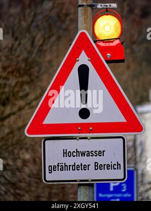 Warning sign for an area at risk of flooding on the Lenne river in Altena, Germany Stock Photo