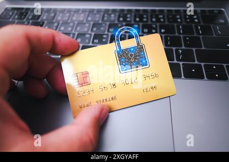 Close up of human hand holding credit or debit card with padlock, protection of financial transactions, copy space, Financial security concept Stock Photo