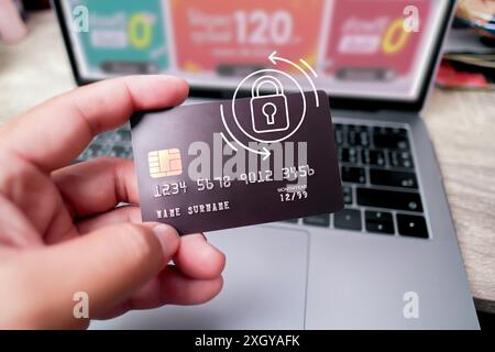 Close up of human hand holding credit or debit card with security padlock for shopping online , protection of financial transactions, copy space Stock Photo