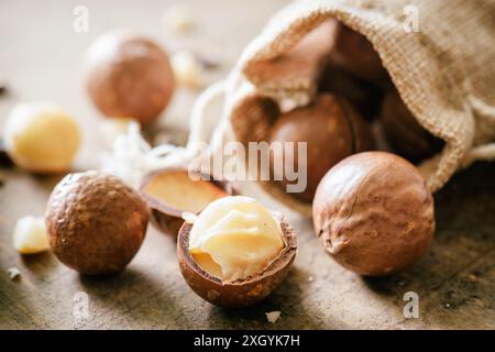 Closeup view of Macadamia nuts on wooden board. Stock Photo