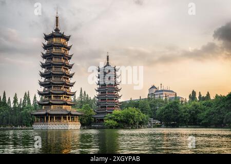 Amazing evening view of the Sun and Moon Twin Pagodas at Shanhu Lake (Fir Lake) in downtown of Guilin, China. Stock Photo