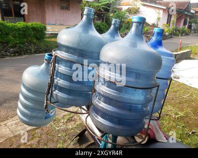 West Java, Indonesia - July 10, 2024 : Seller of refillable mineral water in gallon bottles in West Java, Indonesia Stock Photo