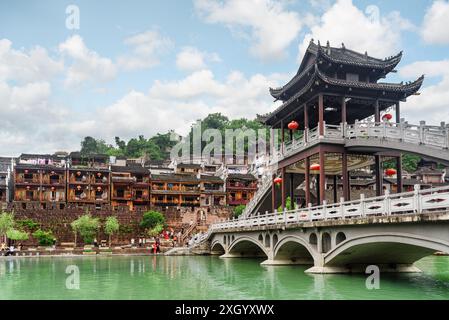 View of amazing bridge reflected in water of the Tuojiang River (Tuo Jiang River) in Phoenix Ancient Town (Fenghuang County), China. Stock Photo