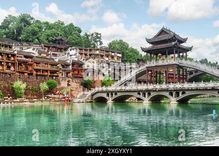 View of amazing bridge reflected in water of the Tuojiang River (Tuo Jiang River) in Phoenix Ancient Town (Fenghuang County), China. Stock Photo