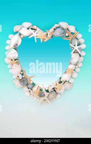 Heart shape sea shell and oyster pearl frame on gradient turquoise and white background. Abstract summer marine life nature border. Stock Photo