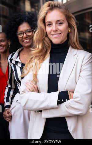 Team of multiracial and diverse businesswomen posing in a row smiling for the camera. Stock Photo