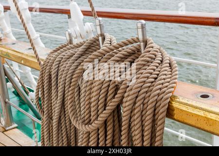 Pine trail with fixed running rigging. An old sailing ship. Closeup of the rigging of an old boat on a sunny day Stock Photo