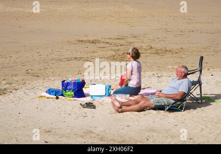relaxing on the beach at trevone in north cornwall Stock Photo