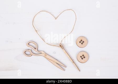 Template for tailors with needle and button figurines on wooden surface Stock Photo