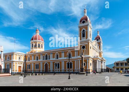 Granada, Nicaragua - March 24, 2019: A vibrant display of colonial architecture under a serene blue sky. Stock Photo