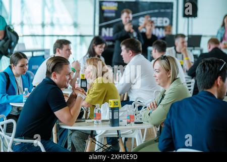 Moscow - April 10,2024: Professionals networking and engaging in discussions at business event Open Innovations Conference in Skolkovo Technopark at modern hall Stock Photo